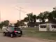 VHF Grid Activation — DM86 in Stratford Texas Black SUV parked on a residential street at sunset with a small house, trees, and a tall TV antenna nearby.
